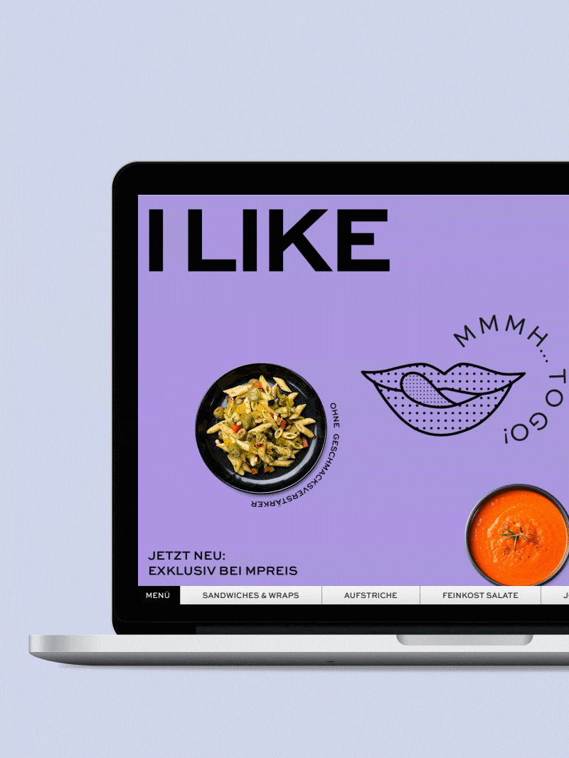 Ein Laptop zeigt die Website von "I LIKE" mit Speisen und dem Slogan "MMMH...TO GO!".