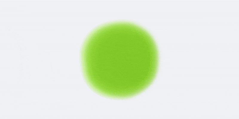 Ein heller, unscharfer grüner Kreis auf einem weißen Hintergrund.